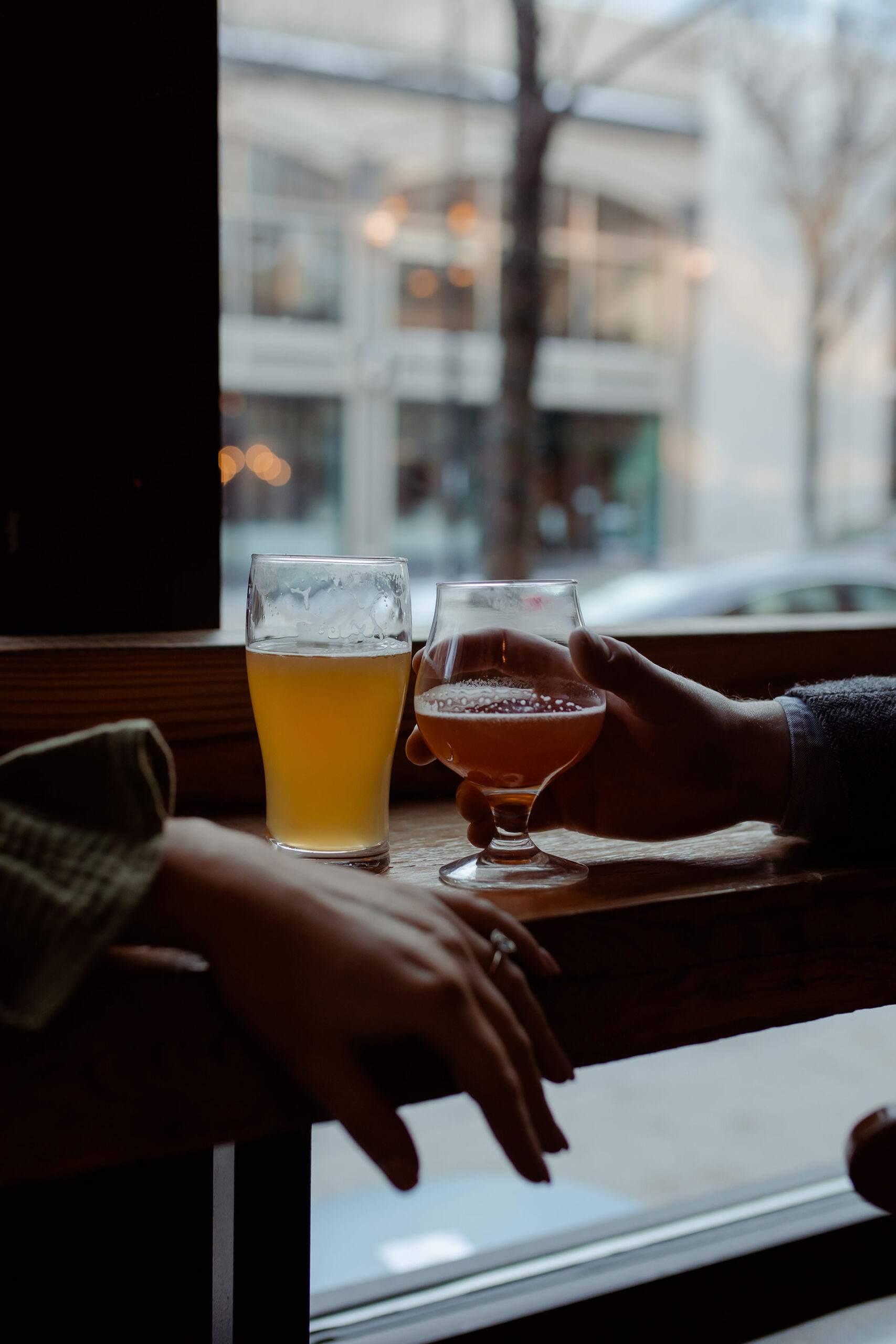 A couple in a suit + white dress take engagement photos at a brewery in Madison, WI by Claire Neville Photography 