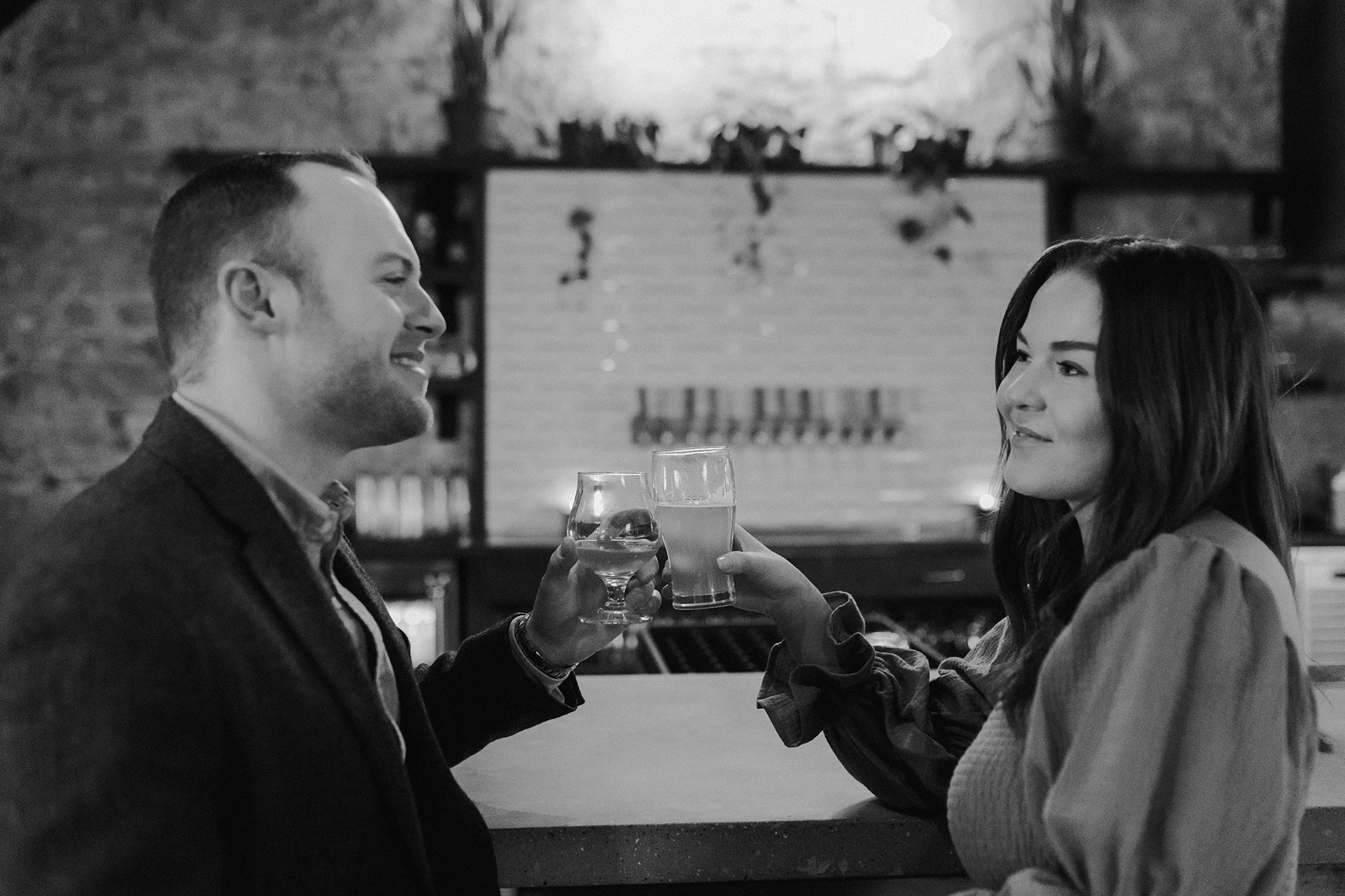 A couple in a suit + white dress take engagement photos at a brewery in Madison, WI by Claire Neville Photography 