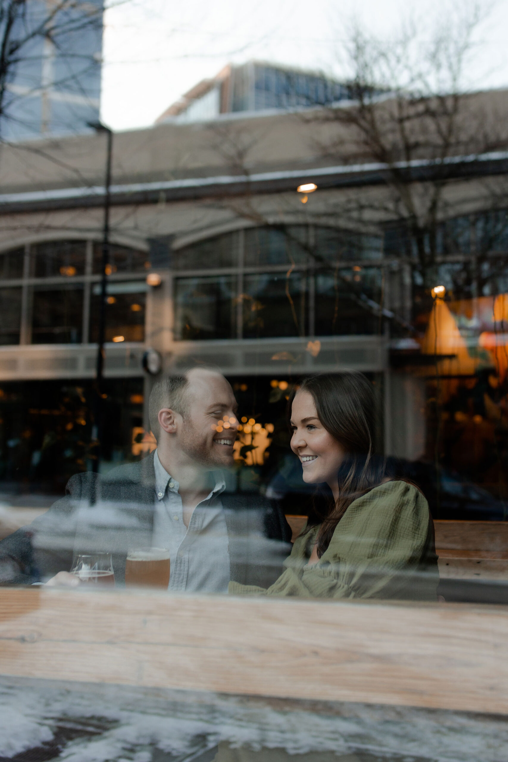 A couple in a suit + white dress take engagement photos at a brewery in Madison, WI by Claire Neville Photography 