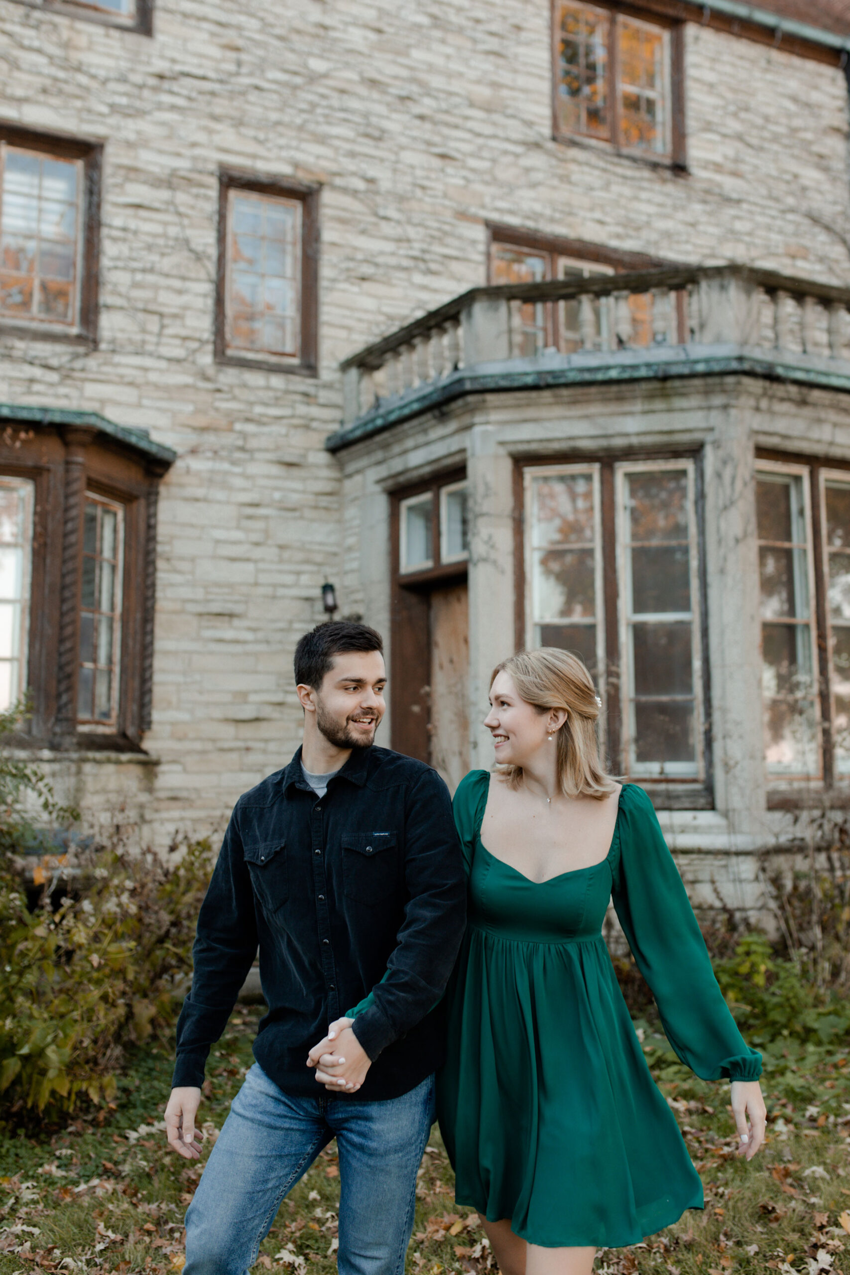 A couple poses in Evanston Illinois in front of an old lighthouse and beautiful sunset for an engagement session with Claire Neville photography. 