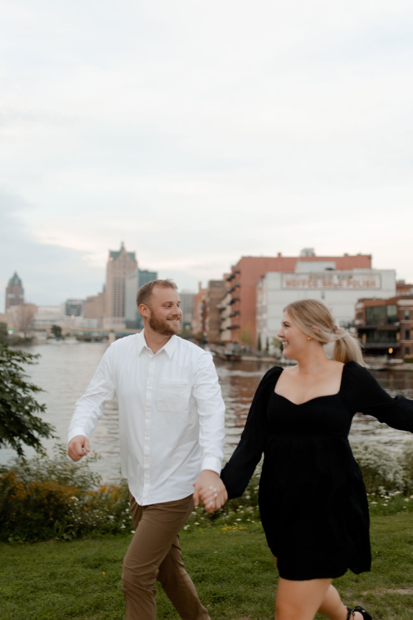 A in milwaukee posing for engagement photos that are documentary style captured by Claire Neville Photography