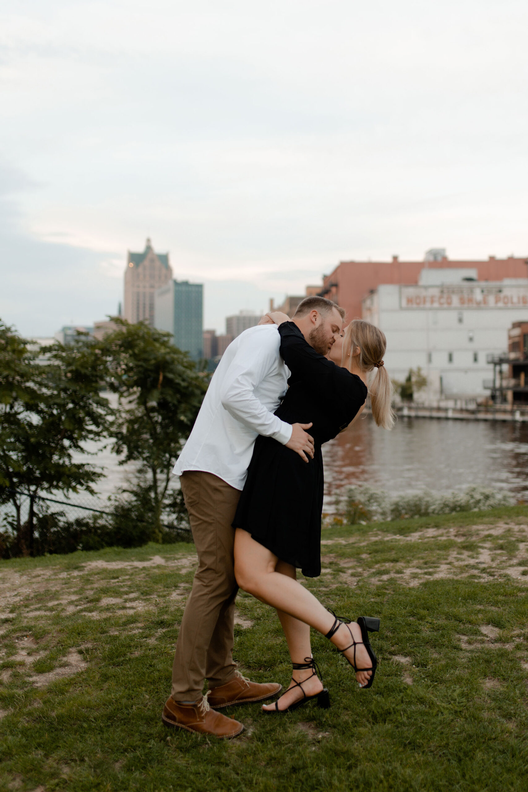 A in milwaukee posing for engagement photos that are documentary style captured by Claire Neville Photography